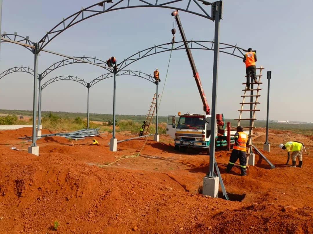 Multi-Bay Curved Carport — fabricated curved arch portal frames, Uganda