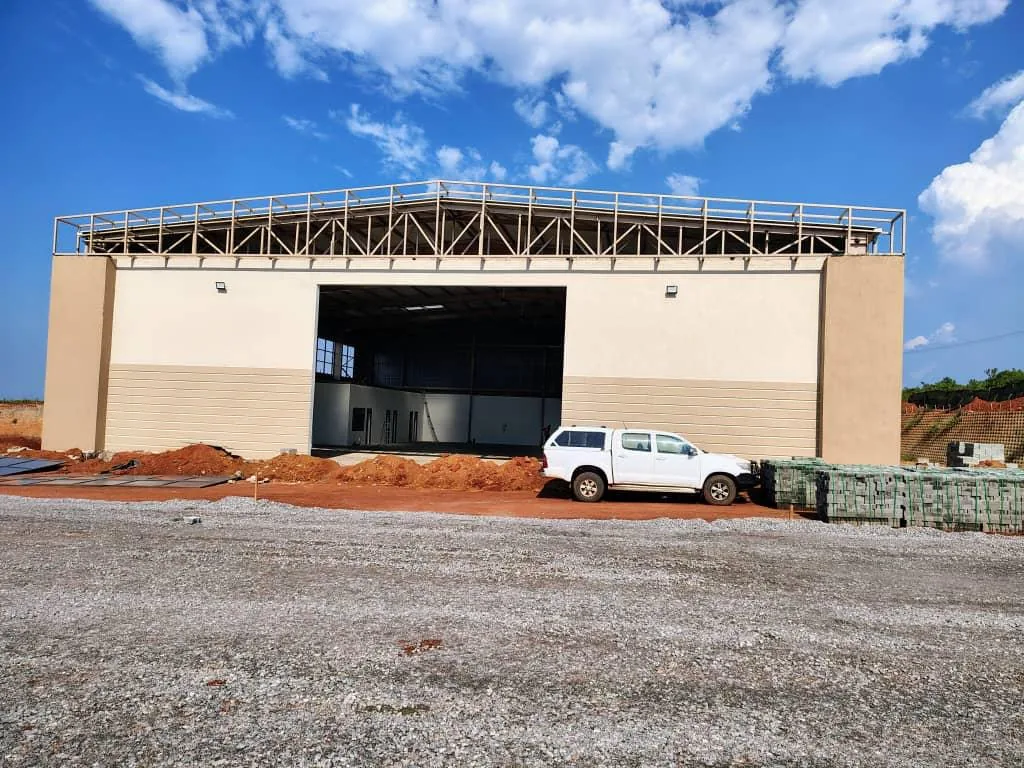 Maintenance Warehouse Nakasongola — steel portal frame and rendered facade, exterior